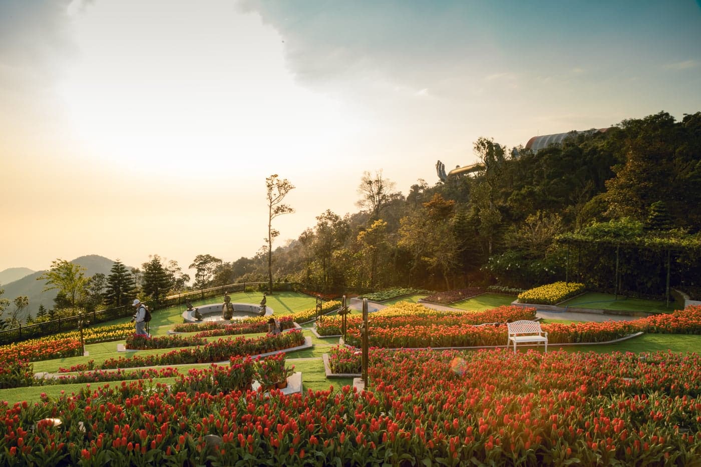 Hilltop Thai temple complex with golden statues and infinity pool overlooking valley, northern Thailand