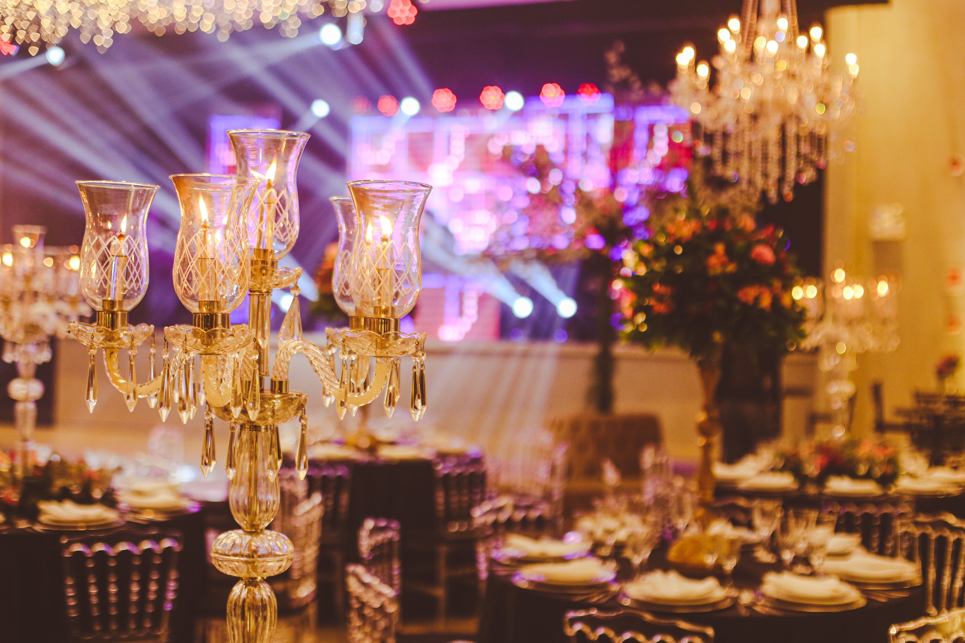 Crystal candelabra, glassware and florals on a table set for a gala dinner